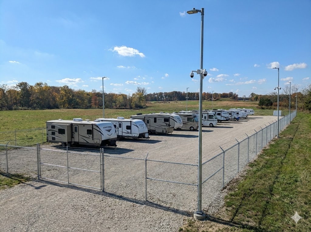RVs and travel trailers parked in the fenced, monitored outdoor storage lot